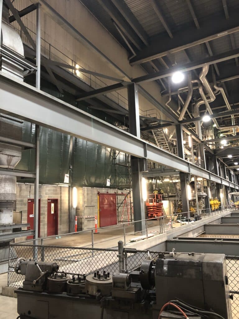 Green/Grey Sonic Acoustic curtains hanging, effectively absorbing noise for Energy Australia, promoting a quieter environment.