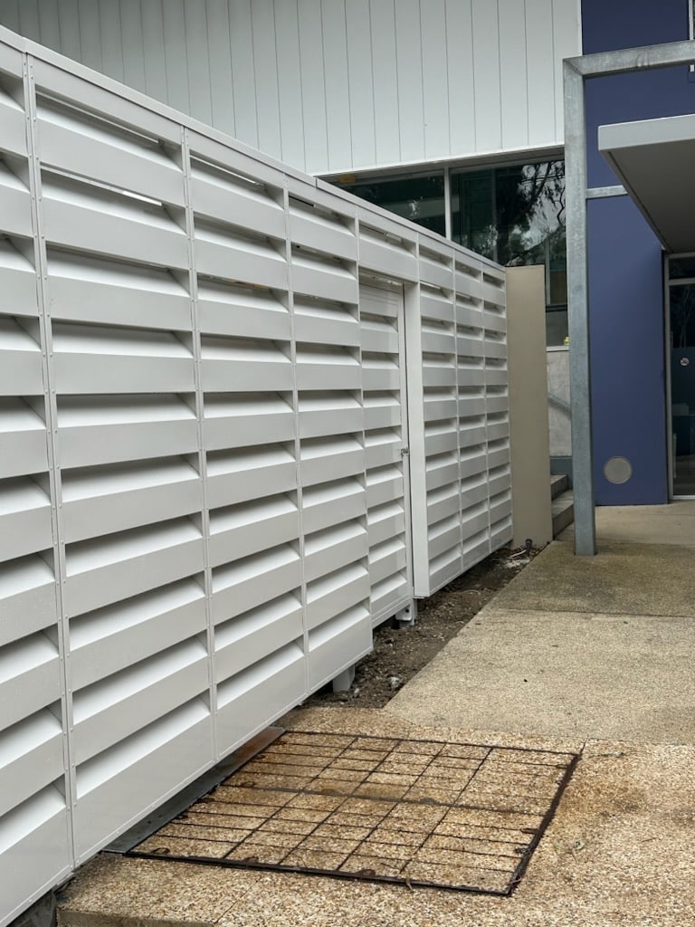 Light coloured acoustic louvres with a lourvre door for noise control