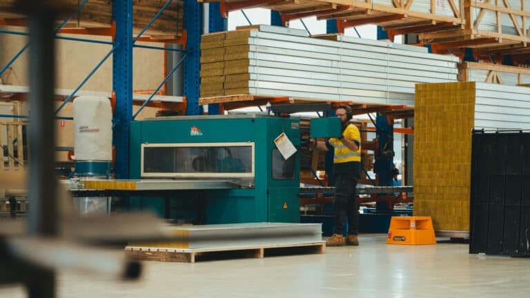 A worker with hearing protection in a manufacturing facility.