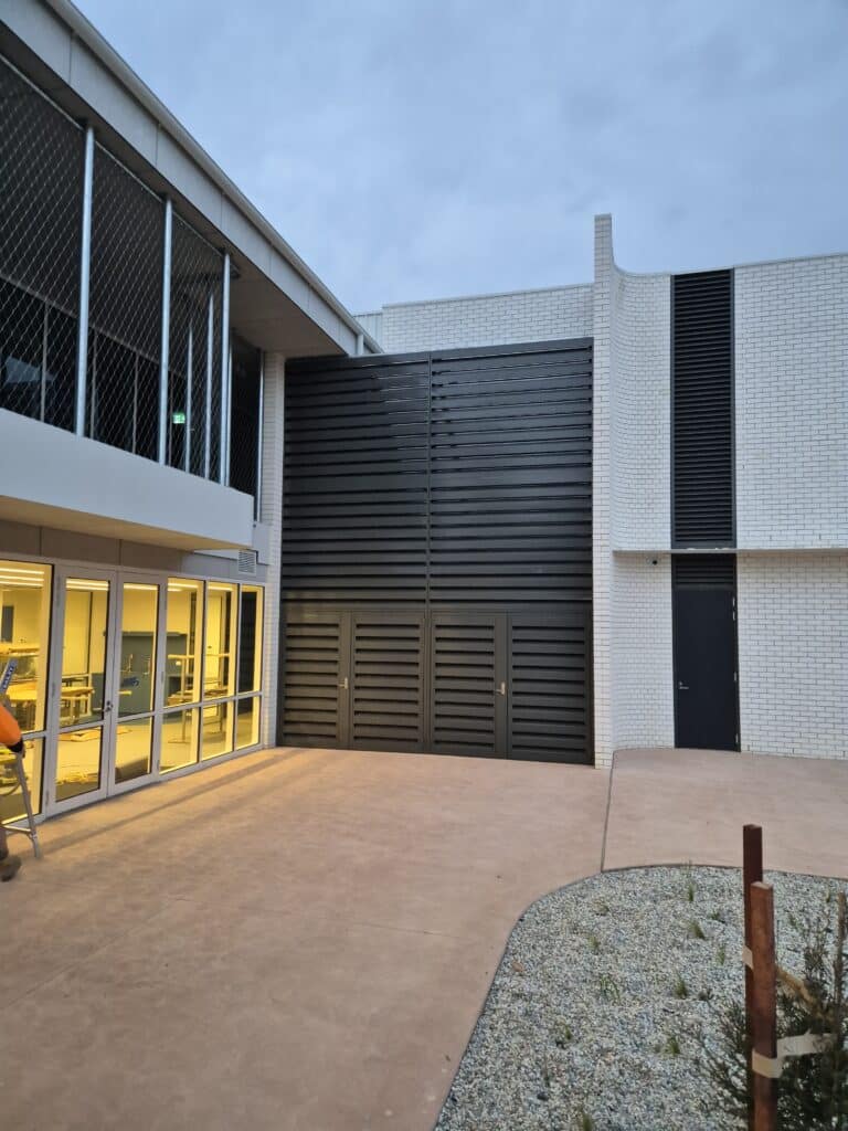 Custom-built acoustic louvres reduce HVAC noise, protecting learning environments while maintaining airflow and site aesthetics.