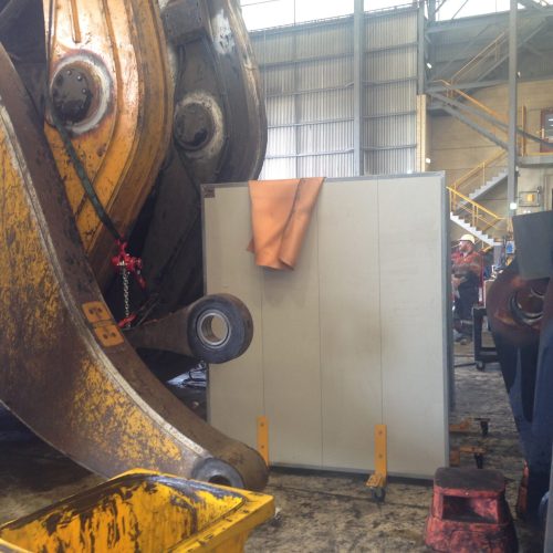 Sonic System mobile acoustic panel positioned beside large mining equipment inside an industrial maintenance workshop at Rio Tinto Hunter Valley.