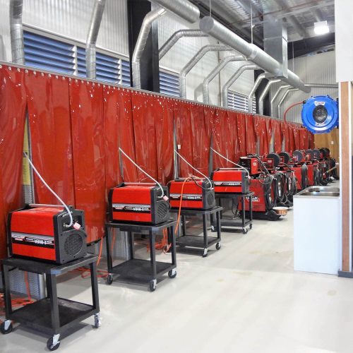 Flexshield WeldflexTM Strip curtains on a welding bay protect students from sparks while learning at a Trade Training Centre.