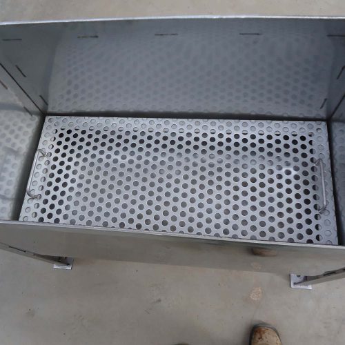 Internal view of Flexshield Quench tank showing perforated base grate and welded stainless steel construction