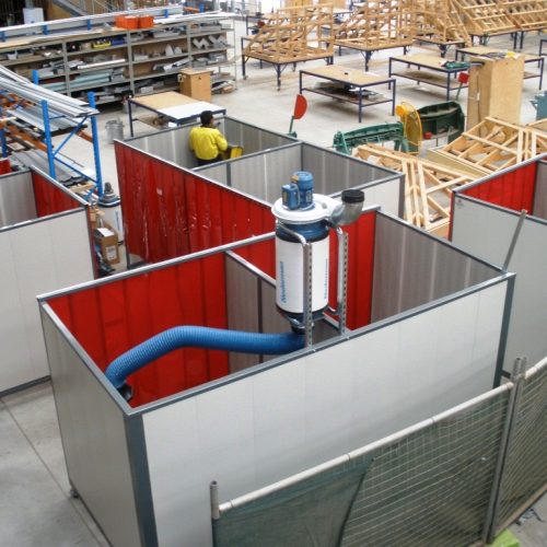 Welding bays with flexible fume extraction ducting and central extraction equipment in an industrial workshop