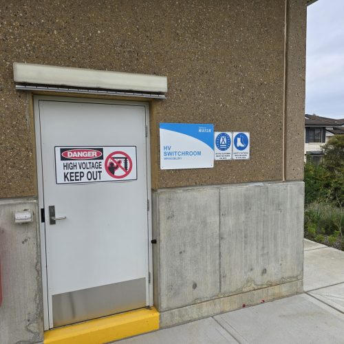 White Sonic Access acoustic door installed at a Sydney Water high-voltage switchroom.