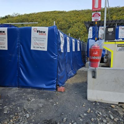Blue Flexshield Sonic Acoustic Curtain reducing the impact of generator noise.