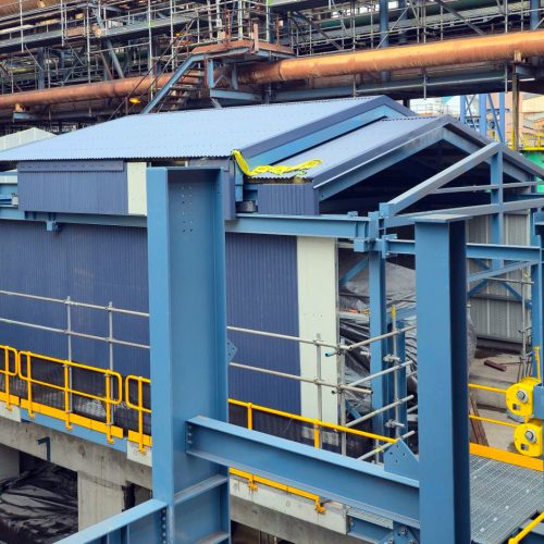 Large industrial Sonic acoustic enclosure installed within a steel processing facility