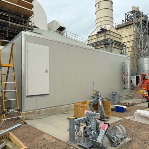 Exterior view of a Sonic acoustic enclosure installed at an industrial site