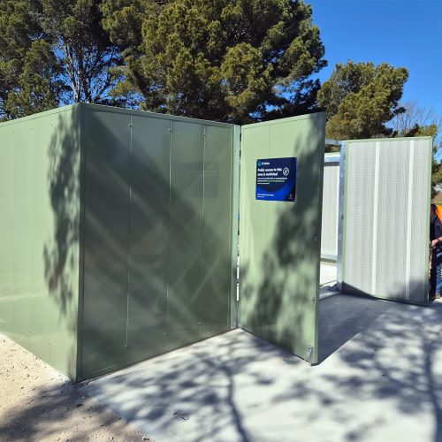 Green outdoor Sonic acoustic enclosure with large hinged access panel