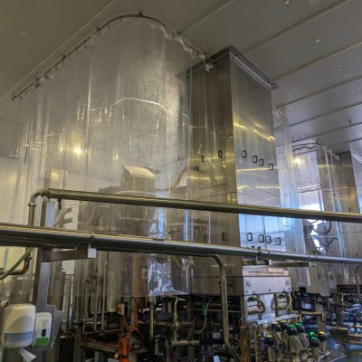 L-shaped stainless track with smooth radius corner for seamless curtain movement in confined food-grade spaces.