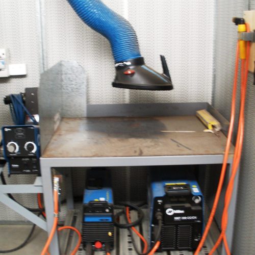 Flexshield Welding tables with welding equipment storage and overhead fume extraction arm
