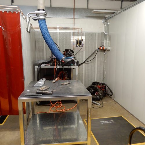 Flexshield Welding tables in a welding bay with overhead extraction, workshop services and equipment storage