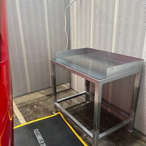 Compact Flexshield Welding tables with steel work surface and raised sides in an industrial workshop