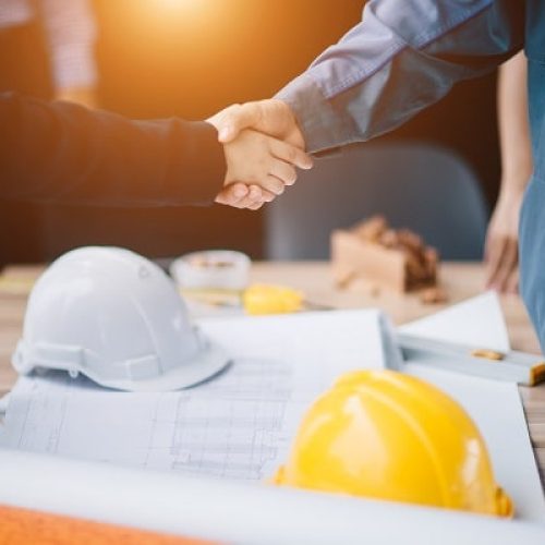 Businessman and engineer handshake closing a deal in construction site. Sucessful,engineering and business concept.