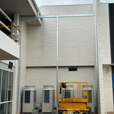 Templeton Primary School HVAC units pre-install—awaiting Flexshield acoustic louvres to ensure quiet, compliant operation in learning spaces.
